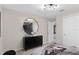 A stylish bedroom featuring a sleek dresser with decorative mirror and modern accents at 1959 Branched Oak Rd, St Cloud, FL 34771
