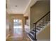 Bright entryway features tile floors and a staircase to the second floor at 2341 Baronsmede Ct, Winter Garden, FL 34787