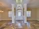 Bright foyer featuring a decorative front door, tiled floors, and elegant lighting fixture at 2341 Baronsmede Ct, Winter Garden, FL 34787