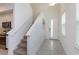 Bright entryway with stairs, tile flooring, and natural light, adjacent to a modern kitchen at 2472 Firstlight Way, Winter Park, FL 32792