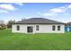 Spacious backyard showcasing a well maintained lawn and sliding glass doors at 2480 Sw 147Th Lane Rd, Ocala, FL 34473