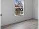 Bright bedroom featuring a large window, white walls, and light wood-look flooring at 2480 Sw 147Th Lane Rd, Ocala, FL 34473