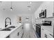 Open concept kitchen boasts stainless steel appliances, white cabinetry, and an undermount sink at 2480 Sw 147Th Lane Rd, Ocala, FL 34473