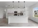 Bright kitchen features white cabinets, stainless steel appliances, pendant lighting, and a large center island at 2480 Sw 147Th Lane Rd, Ocala, FL 34473