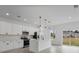 Bright kitchen boasts white cabinets, stainless steel appliances, and an island perfect for meal prep and entertaining at 2480 Sw 147Th Lane Rd, Ocala, FL 34473