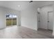 Bright living room featuring stylish gray floors, a sliding glass door to the backyard, and neutral walls at 2480 Sw 147Th Lane Rd, Ocala, FL 34473