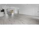 Bright, open-concept living space features a modern kitchen island, sleek gray floors, and abundant natural light at 2480 Sw 147Th Lane Rd, Ocala, FL 34473