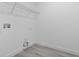 A clean and simple utility room with white walls and light wood-look flooring at 2480 Sw 147Th Lane Rd, Ocala, FL 34473