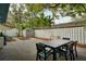 Backyard featuring a shed, lush landscaping, a dining table, and a privacy fence at 2504 Helen Ave, Orlando, FL 32804