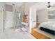 Modern bathroom featuring a glass shower enclosure, shelving, and access to the main bedroom at 2504 Helen Ave, Orlando, FL 32804