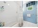 Bathroom featuring a shower over tub, tile surround, and a window at 2504 Helen Ave, Orlando, FL 32804