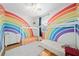 Bright bedroom featuring rainbow decor, a ceiling fan, hardwood floors, and two beds at 2504 Helen Ave, Orlando, FL 32804