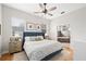 Bright bedroom featuring hardwood floors, a ceiling fan, and an ensuite bathroom with a soaking tub at 2504 Helen Ave, Orlando, FL 32804