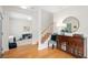 Bright entryway featuring hardwood floors, a wooden staircase, and stylish furnishings and decor at 2504 Helen Ave, Orlando, FL 32804