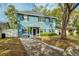 Charming blue two-story home with a welcoming front porch and well-maintained landscaping at 2504 Helen Ave, Orlando, FL 32804