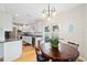 Modern kitchen with white cabinetry, stainless steel appliances, and a cozy breakfast nook at 2504 Helen Ave, Orlando, FL 32804