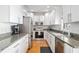 Well-lit kitchen featuring white cabinets, stainless steel appliances, and granite countertops at 2504 Helen Ave, Orlando, FL 32804