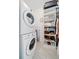 Laundry room showcasing a stacked washer and dryer, shelving, and storage at 2504 Helen Ave, Orlando, FL 32804