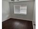 Comfortable bedroom featuring wood flooring and natural light from the window at 2727 W Oak Ridge Rd # 5-6, Orlando, FL 32809