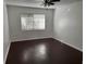 Bright bedroom with wood flooring and a ceiling fan at 2727 W Oak Ridge Rd # 5-6, Orlando, FL 32809