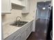 Updated kitchen showcasing a stainless steel sink, granite countertop, and ample cabinet space at 2727 W Oak Ridge Rd # 5-6, Orlando, FL 32809