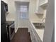 Well-lit kitchen with modern appliances, white cabinets, and ample counter space at 2727 W Oak Ridge Rd # 5-6, Orlando, FL 32809