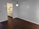 Open concept living room with wood flooring and views of the kitchen at 2727 W Oak Ridge Rd # 5-6, Orlando, FL 32809
