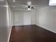 Spacious living room featuring hardwood floors, ceiling fan, and sliding glass doors at 2727 W Oak Ridge Rd # 5-6, Orlando, FL 32809