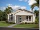 Charming single-story home with a covered front porch, well-manicured lawn, and beautiful landscaping at 2953 Sailhouse Dr, St Cloud, FL 34771