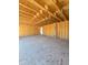 Unfinished garage shows concrete floor and the walls with the framing at 2953 Sailhouse Dr, St Cloud, FL 34771