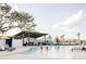 Community pool with people relaxing and children playing in the water on a sunny day at 2953 Sailhouse Dr, St Cloud, FL 34771