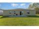 Home's backyard featuring simple patio and lush green lawn at 322 Dagama Ct, Kissimmee, FL 34758