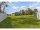 Expansive backyard with lush green grass, a simple patio, and partial fence at 322 Dagama Ct, Kissimmee, FL 34758
