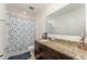 Bathroom featuring granite countertops and patterned shower curtain at 322 Dagama Ct, Kissimmee, FL 34758