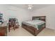 Bedroom features a large window, tile floors, ceiling fan and is furnished with a wooden bed, desk and chair at 322 Dagama Ct, Kissimmee, FL 34758