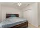 This neutrally-toned bedroom features a ceiling fan, and a large bed, and the closet provides ample storage at 322 Dagama Ct, Kissimmee, FL 34758
