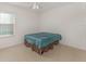 Simple bedroom with neutral walls and a ceiling fan and tile flooring at 322 Dagama Ct, Kissimmee, FL 34758