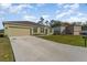 Well-maintained home features an attached garage and a long driveway, providing ample parking space at 322 Dagama Ct, Kissimmee, FL 34758