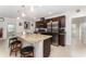 A kitchen showcases a granite island, stainless steel appliances, and dark wood cabinets, creating a modern culinary space at 322 Dagama Ct, Kissimmee, FL 34758