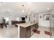 This open-concept kitchen has a granite island, stainless steel appliances, and seamlessly connects to the living and dining areas at 322 Dagama Ct, Kissimmee, FL 34758