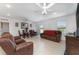 Large living room is perfect for entertaining with tile floors, ceiling fans, and large sliding glass door at 322 Dagama Ct, Kissimmee, FL 34758