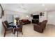 Spacious living room with tile flooring, comfortable brown couches, and dining area at 322 Dagama Ct, Kissimmee, FL 34758
