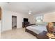 This main bedroom features neutral tile, a ceiling fan, a walk-in closet, and a window offering natural light and backyard views at 322 Dagama Ct, Kissimmee, FL 34758
