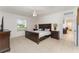Neutral tile flooring and a window showcasing a view of the neighborhood enhances the main bedroom's appeal and comfort at 322 Dagama Ct, Kissimmee, FL 34758