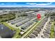 An aerial view shows a residential neighborhood with ponds and green landscaping under a clear, blue sky at 3270 Water Sprite St, Orlando, FL 32808