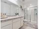 Bright bathroom features a walk-in shower, vanity with granite countertop at 3270 Water Sprite St, Orlando, FL 32808