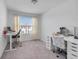 Bright bedroom with dual desks and seating, perfect for a home office at 3270 Water Sprite St, Orlando, FL 32808