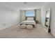 Bright bedroom features a window, carpeted floor, and a mirror at 3270 Water Sprite St, Orlando, FL 32808