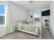 Bright bedroom with neutral decor, large window, and a wall mounted TV at 3270 Water Sprite St, Orlando, FL 32808