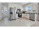 Bright kitchen features stainless steel appliances, granite counters and white cabinetry at 3270 Water Sprite St, Orlando, FL 32808